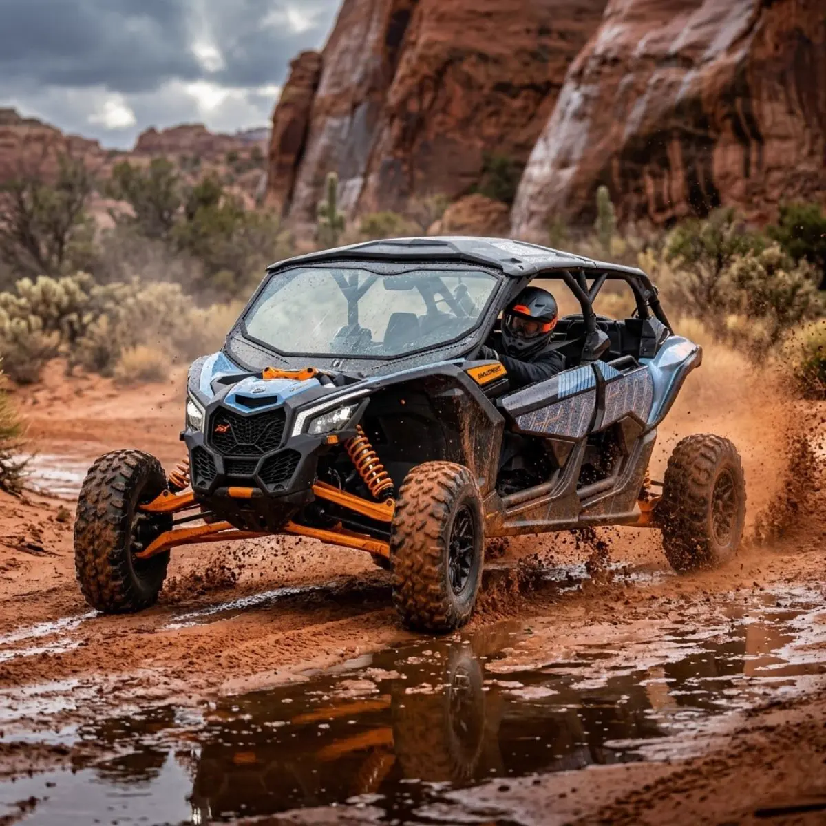 Can-Am UTV powering through a muddy red rock trail