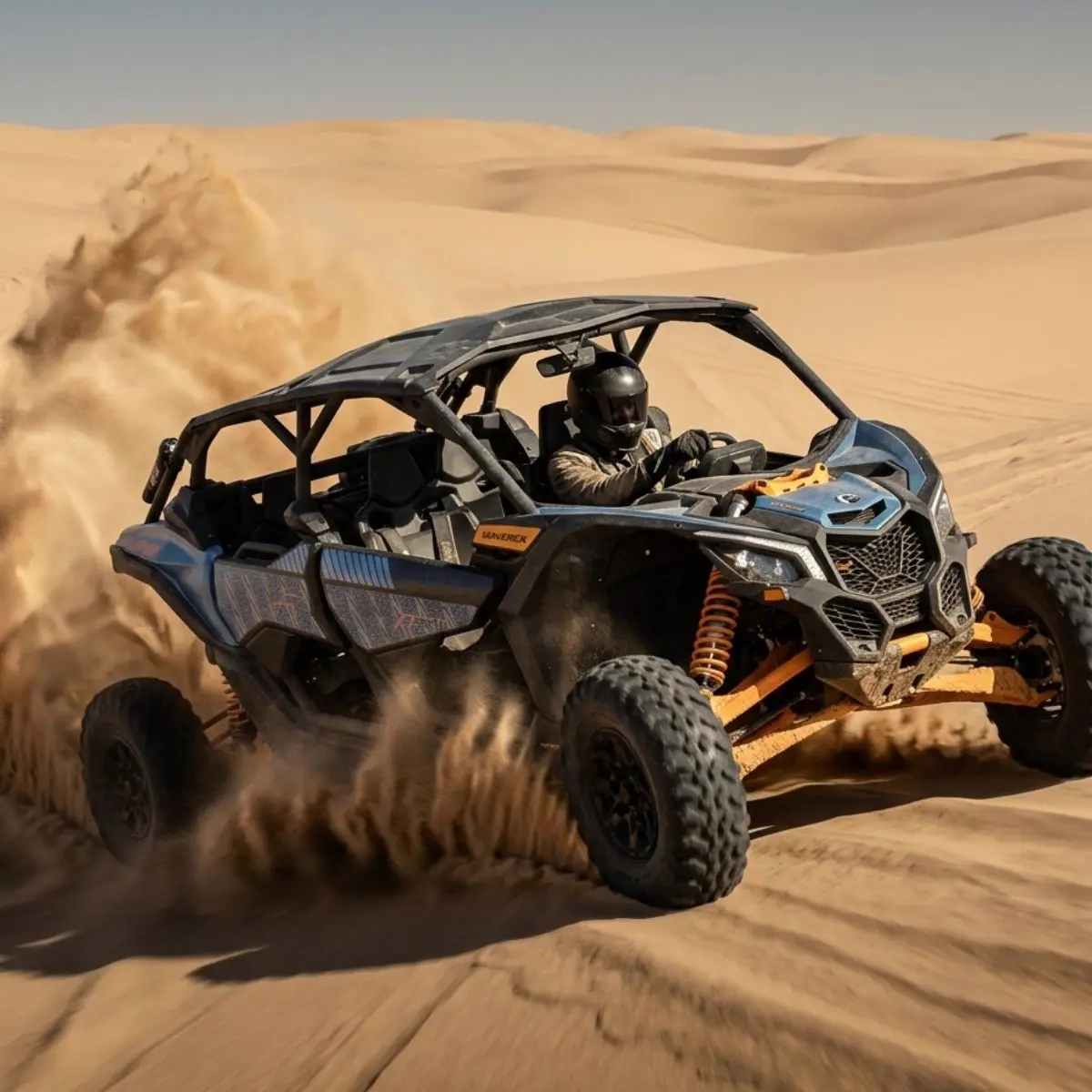 Can-Am Maverick carving turns on golden sand dunes